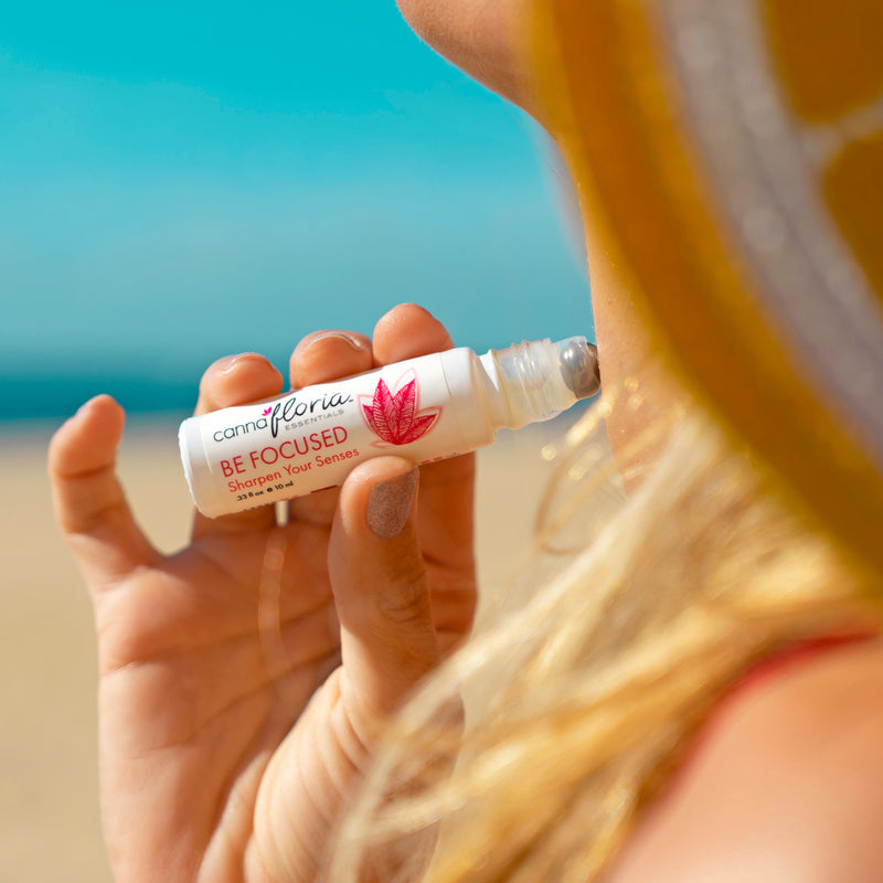 Cannafloria Be Focused Aromatherapy Roll-on being used on neck
