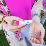 Cannafloria Be Soothed Aromatherapy Roll-on being used on her wrist